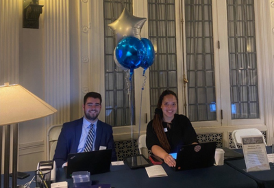 Man and Women sitting at registration table for event 