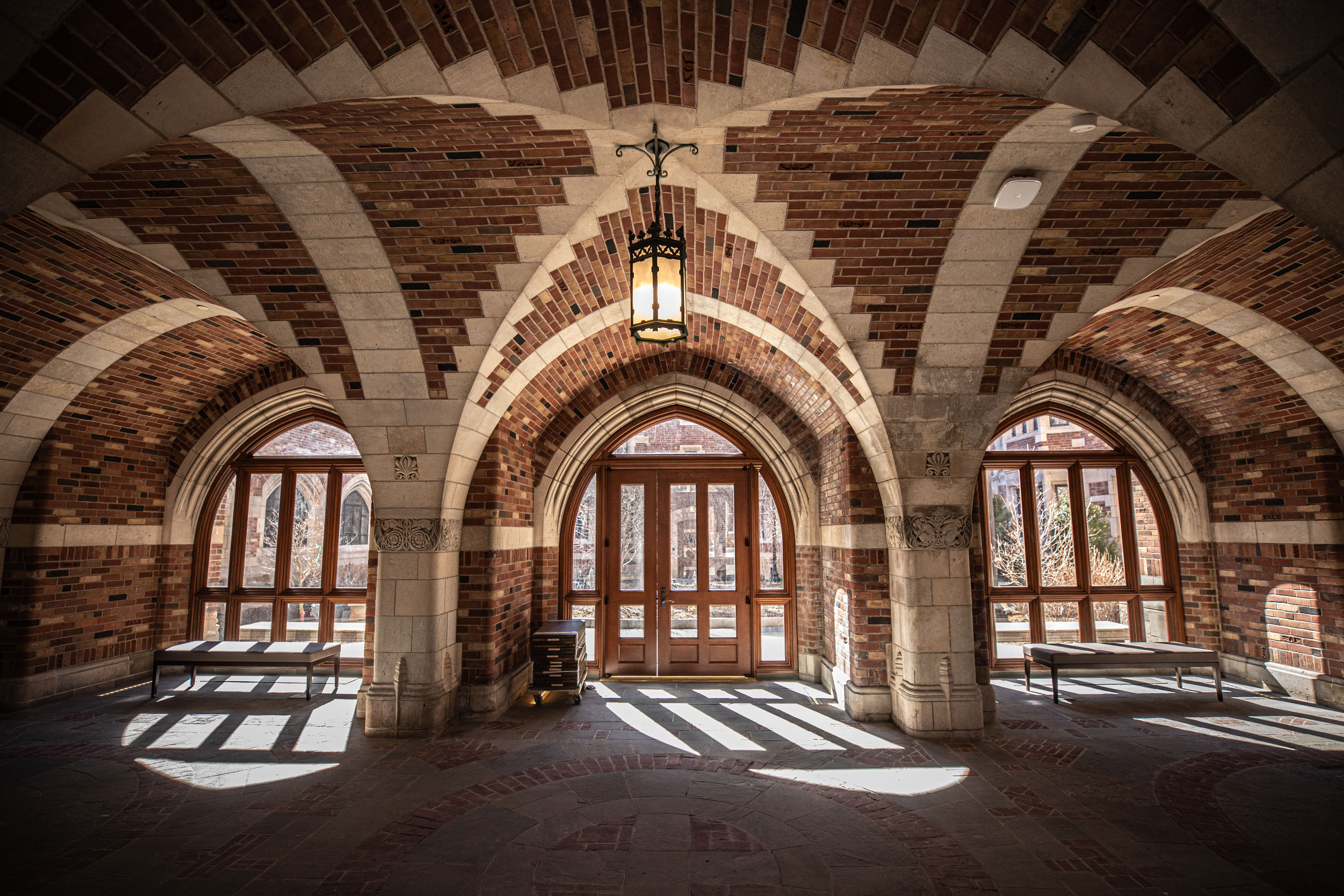 Yale campus doors with light shining through them 