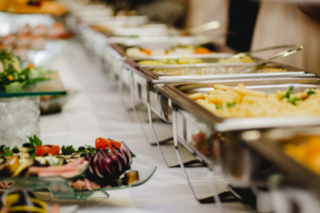 A table of catered food in chafing dishes and beautifully presented.