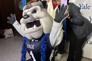 Bulldog mascot posing with new students 