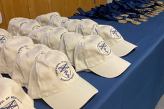 hats lined up on registration table 