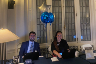 Man and Women sitting at registration table for event 