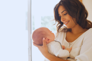 women holding baby 