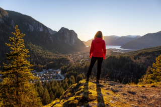 Woman on a mountain edge staring into the distance