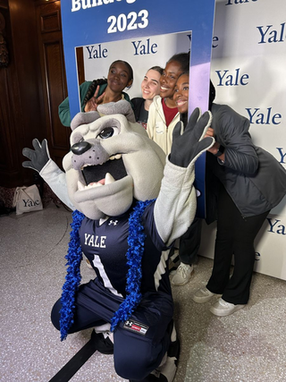 Bulldog mascot posing with new students 