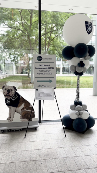  Global Research Alliance for Sustainable Finance and Investment Conference Poster, grey, blue, and white balloons, cardboard cutout of Handsome Dan
