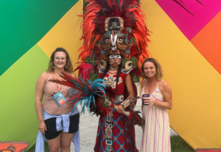 Picture of Shannon attending conference next to decorated local 